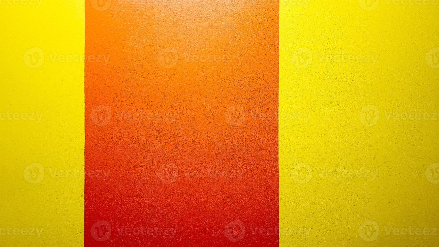 Red and yellow painted wall texture abstract grunge background with copy space. Abstract geometric pattern on the wall. The wall is divided into borders of different colors photo