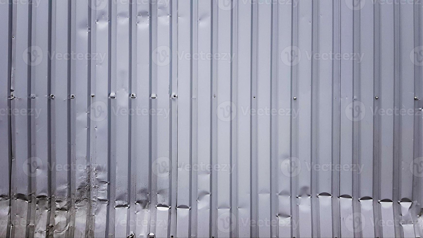 Old zinc abstract. Zinc vintage background view. crumpled metal plate of the fence. Tin roof background with a hole of rust and nails vintage style. Zinc wall surface detail with holes. photo