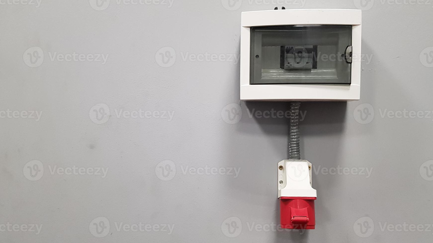 Three-phase 380 V high-voltage plug on a gray wall in a room with copy space. photo