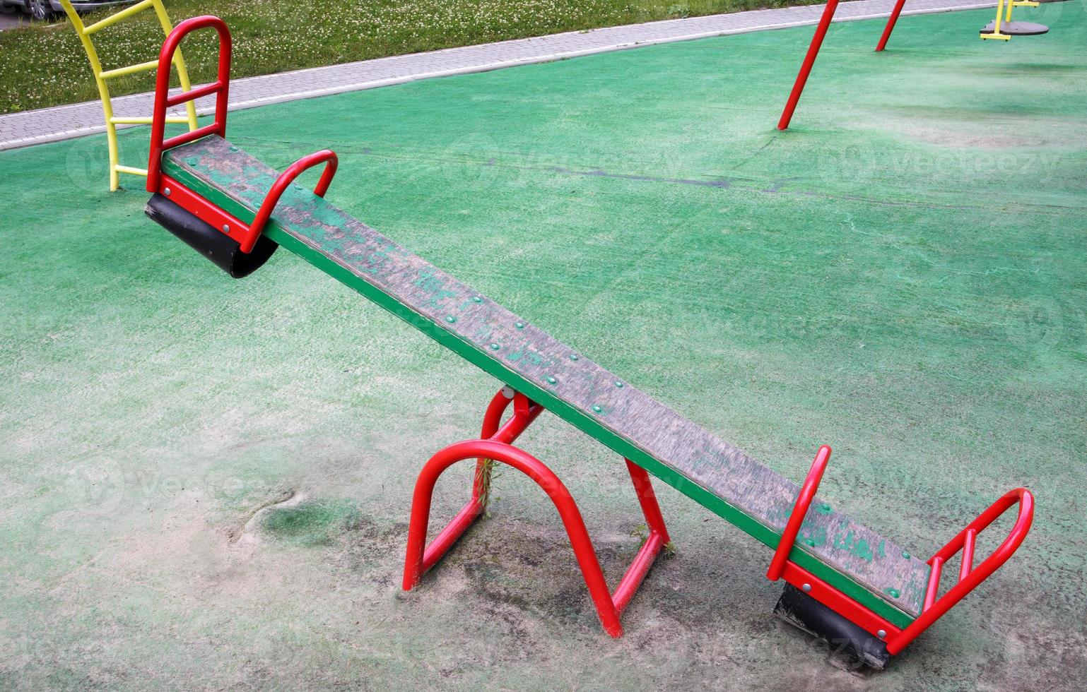 Closed modern playground. Security and protection measures against COVID-19 in the city park. Children's empty swing balancer in the park without people. The concept of childhood is over. photo
