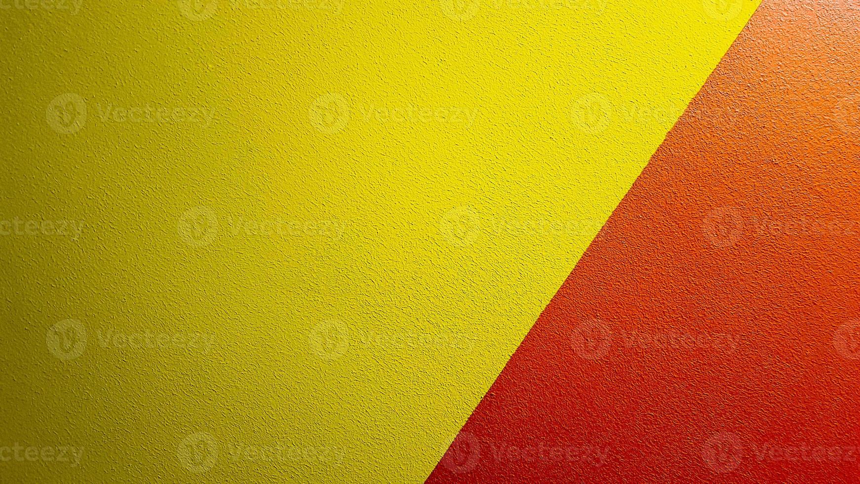 Red and yellow painted wall texture abstract grunge background with copy space. Abstract geometric pattern on the wall. The wall is divided into borders of different colors photo