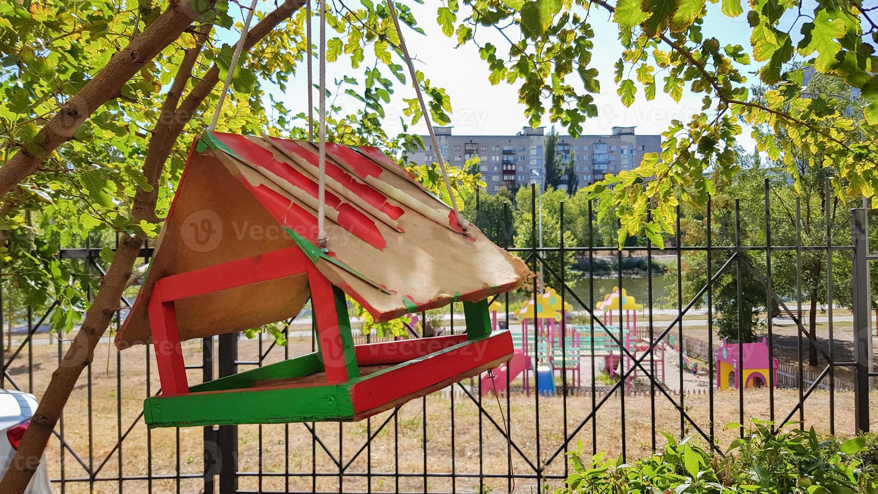 Handmade bird feeders made of wood in a city park. Bird house. photo