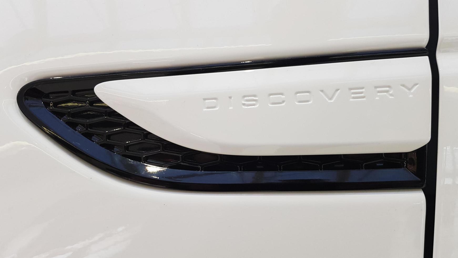 Ukraine, Kiev - March 27, 2020. new white Land Rover Discovery Sport 2019. Side view of the wing and part of the door with the inscription. Medium SUV photo