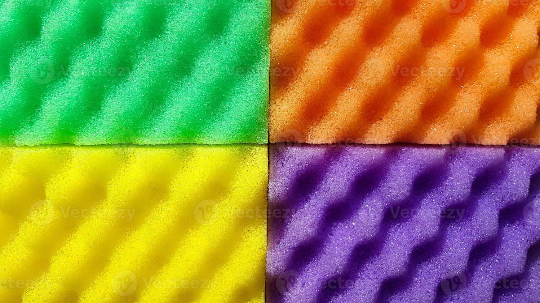 Multi-colored washcloths are laid out in rows on a bright background, close-up. place for text. Copy space photo