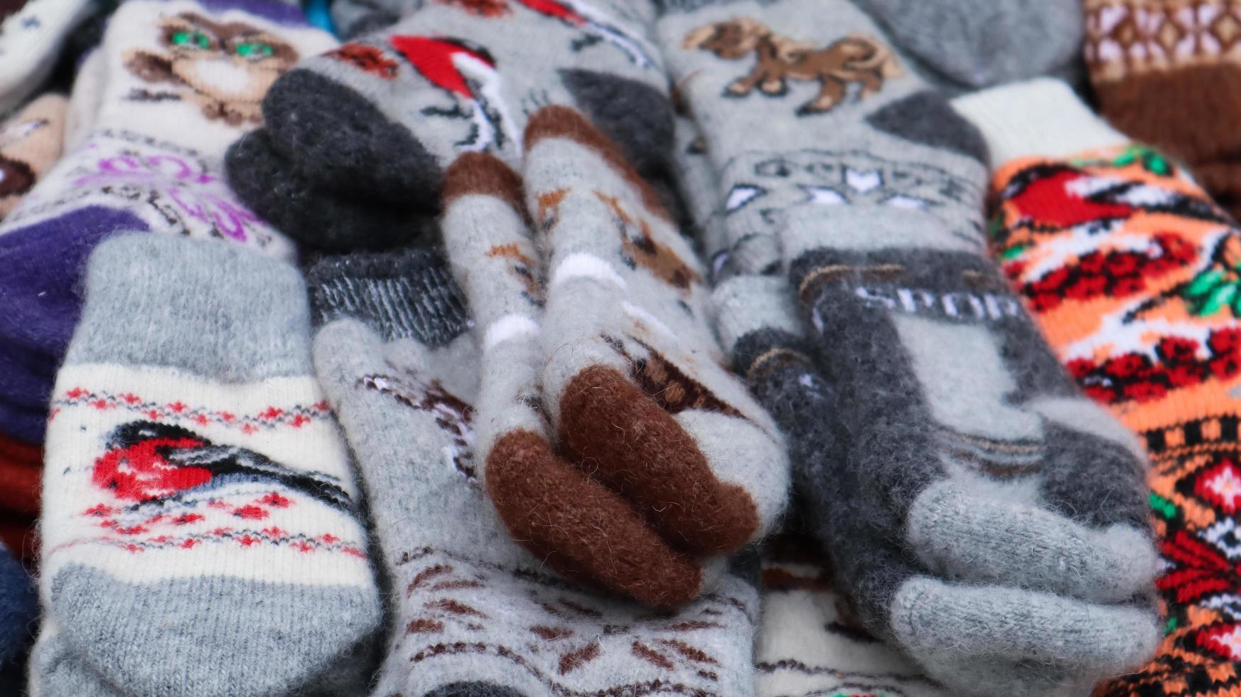 Souvenir market in Yaremche. Close-up of natural woolen knitted socks in the Carpathians. Ukraine, Yaremche - November 20, 2019 photo