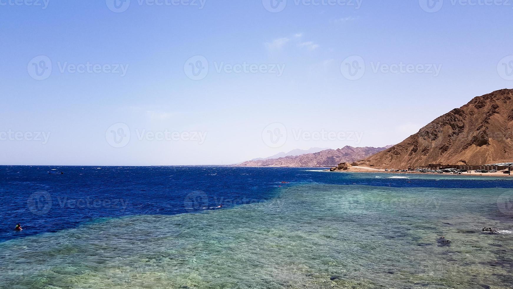 The Blue Hole is a popular diving spot in East Sinai. Sunny beach resort on the Red Sea in Dahab. A famous tourist destination near Sharm el Sheikh. Bright sunshine photo