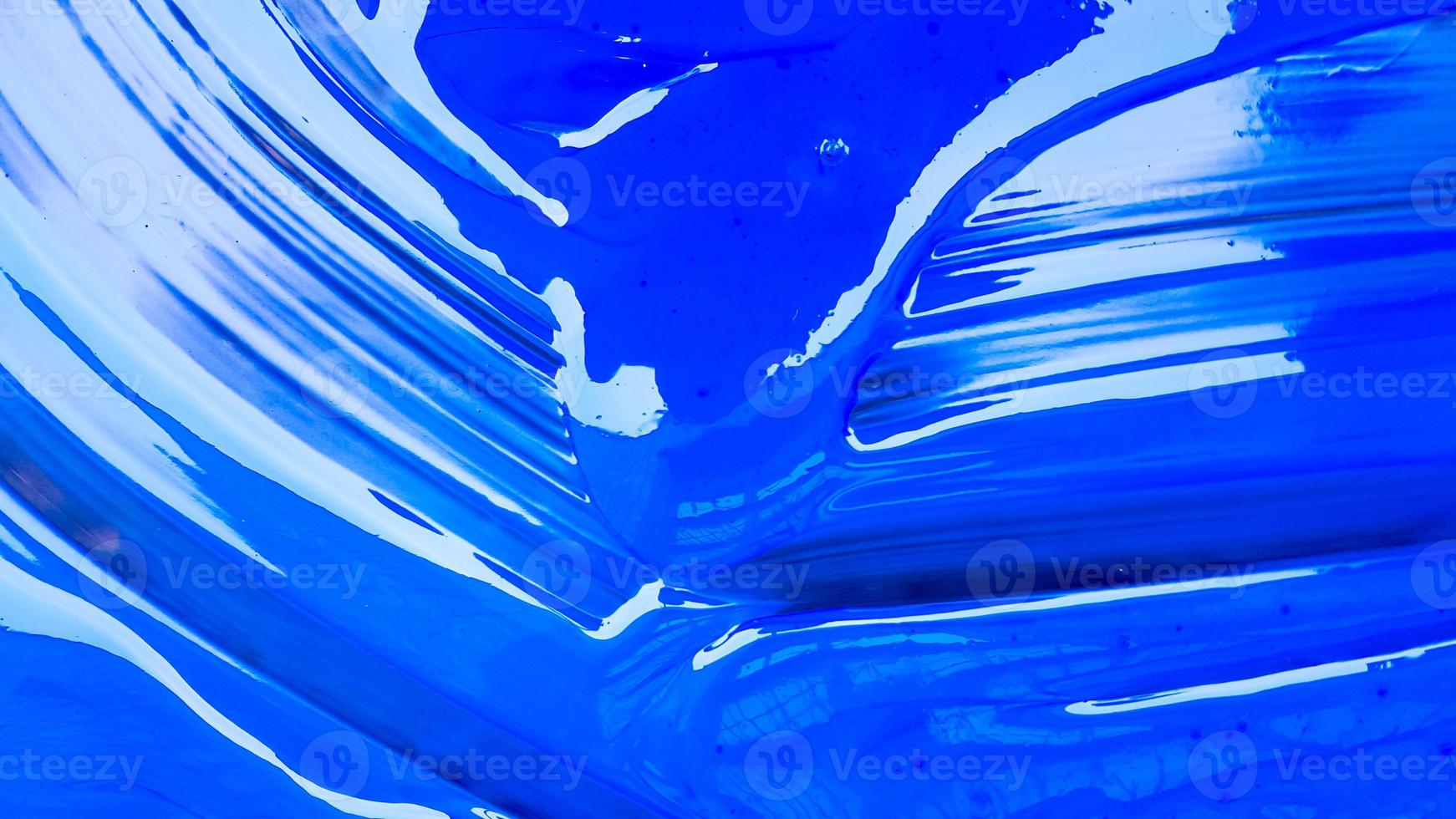 Abstract background of spilled blue paint with buckets on a black background. Blue paint is pouring on a black background. Use it for an artist or creative concept. Paints spilled blue background photo