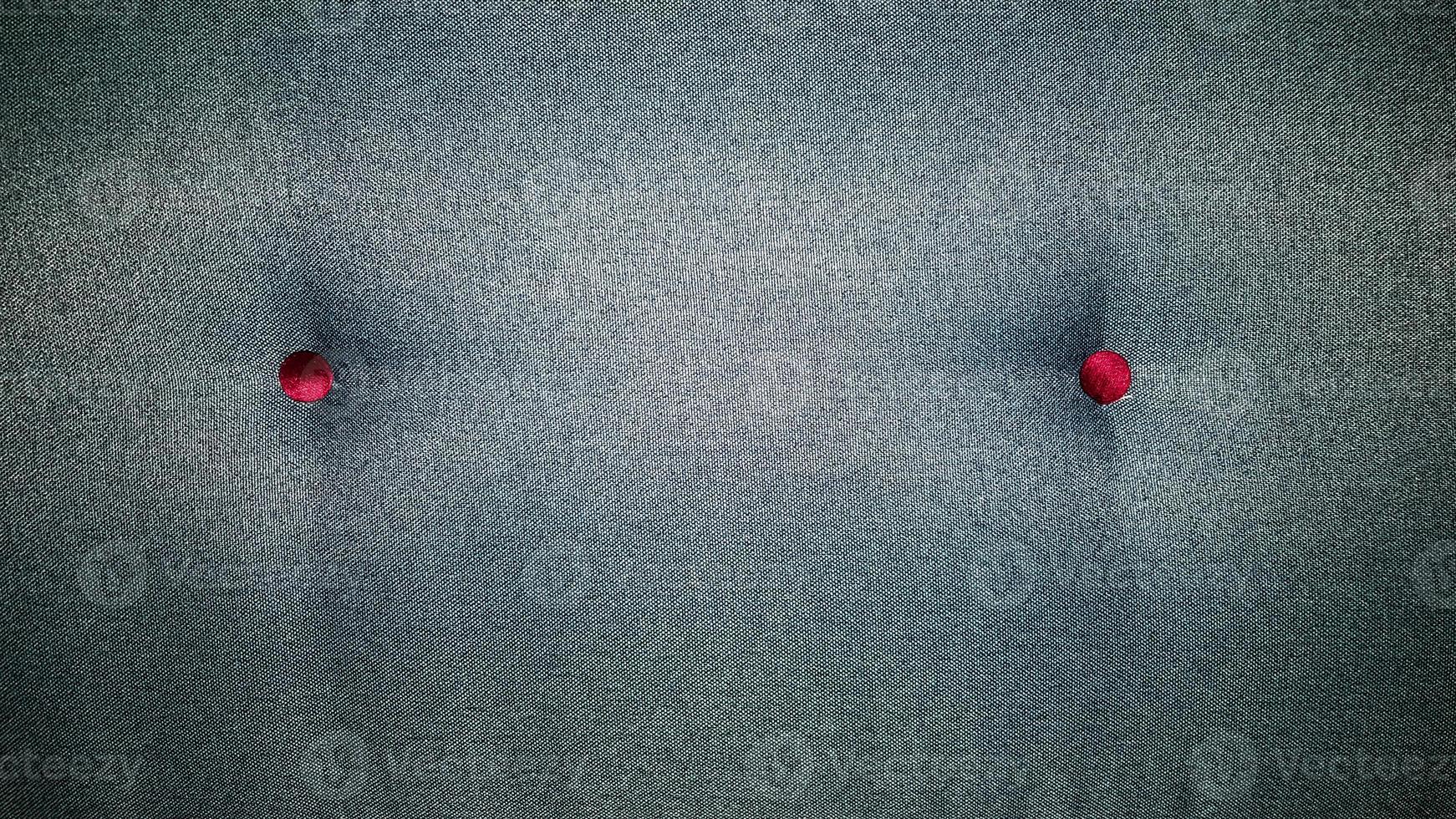Closeup green textile sofa with buttons. Abstract background, upholstered furniture photo