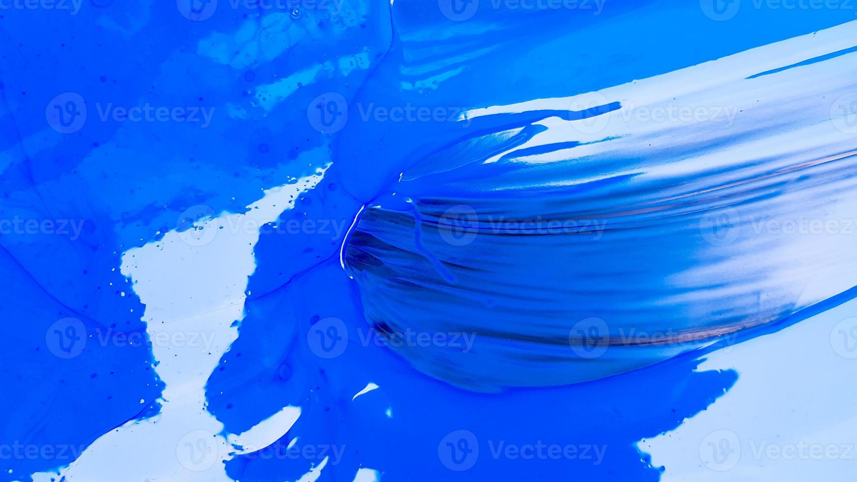 Abstract background of spilled blue paint with buckets on a black background. Blue paint is pouring on a black background. Use it for an artist or creative concept. Paints spilled blue background photo