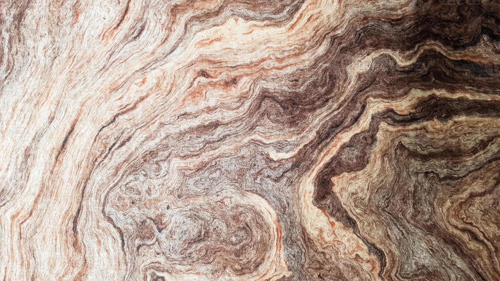 The surface of Sandstone with wavy brown veins. Sulphide agate texture. Wide image of brown natural stone texture Sphalerite. Beautiful wavy pattern of cut of Schalenblende stone close-up photo