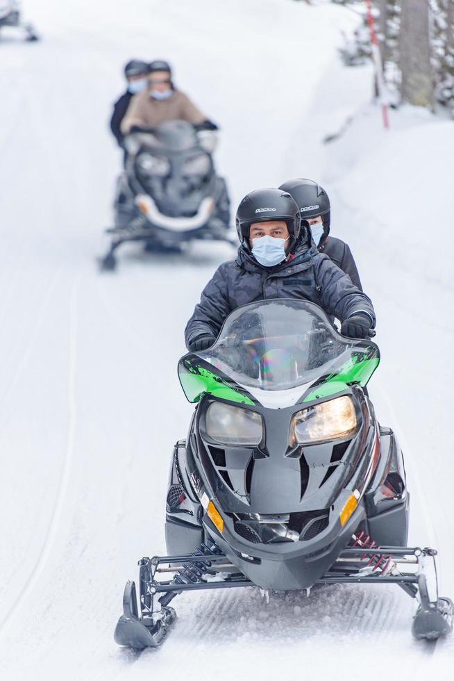 Grandvalira, Andorra . 2021 March 1 . Young people driving snowmobiles at the Grandvalira station, Grau Roig Andorra. photo