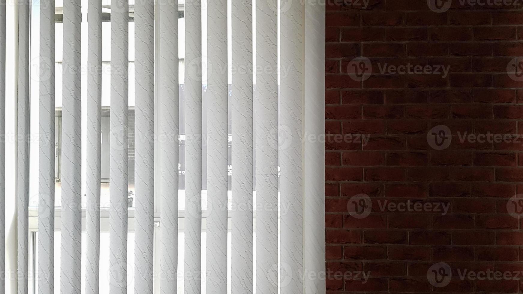 Blinds are attached to the window to protect from heat and sunlight indoors. Roller shutters in the house catch sunlight. photo