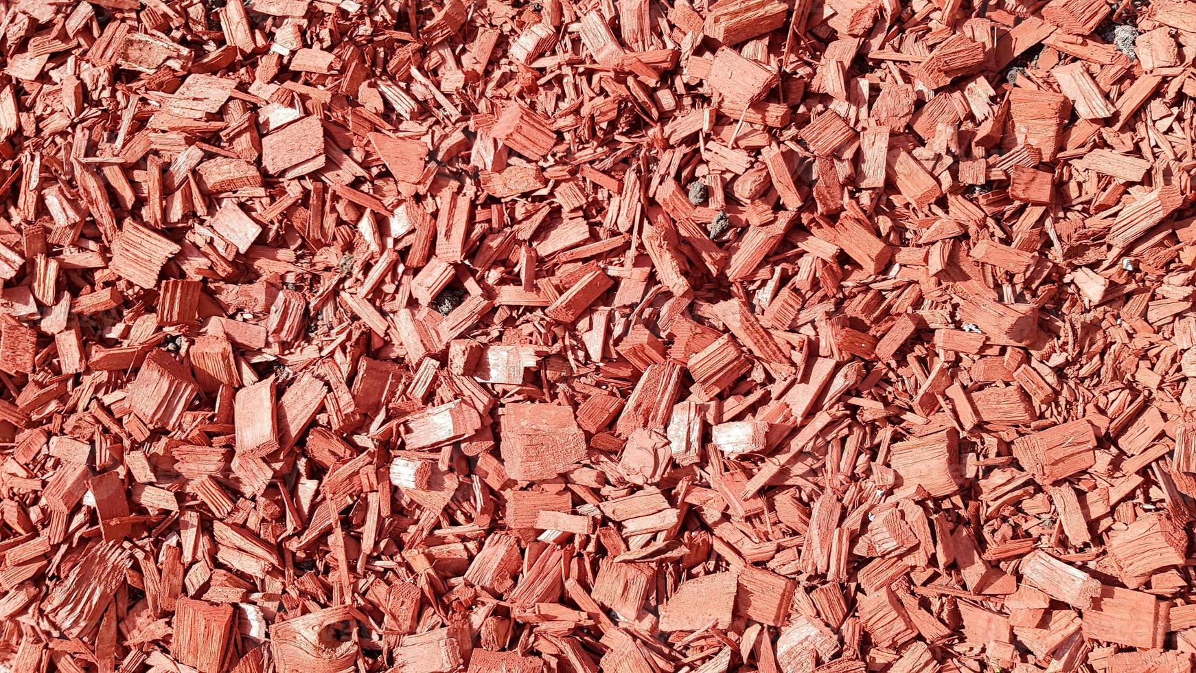 Sawdust for the garden. Texture of tree bark lying on the ground. Background from a tree bark. Decorative bark, mulch, mulching. Decorative wood chips. Natural pine red mulch photo