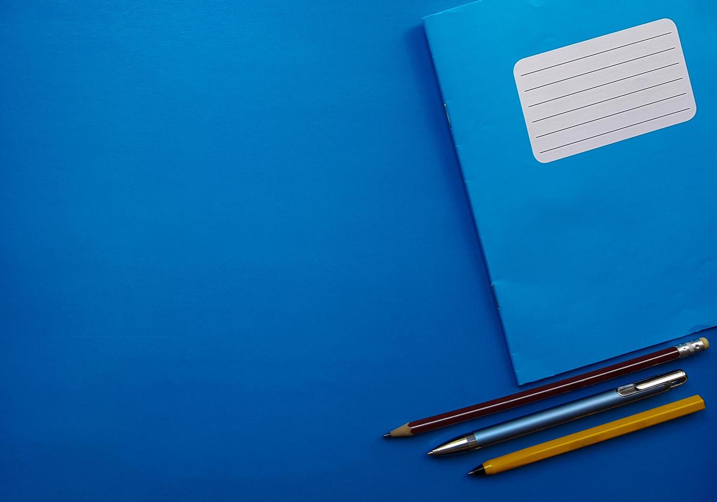 Old copybook on a blue background. School notebook, preparation for September 1 and the new school year photo