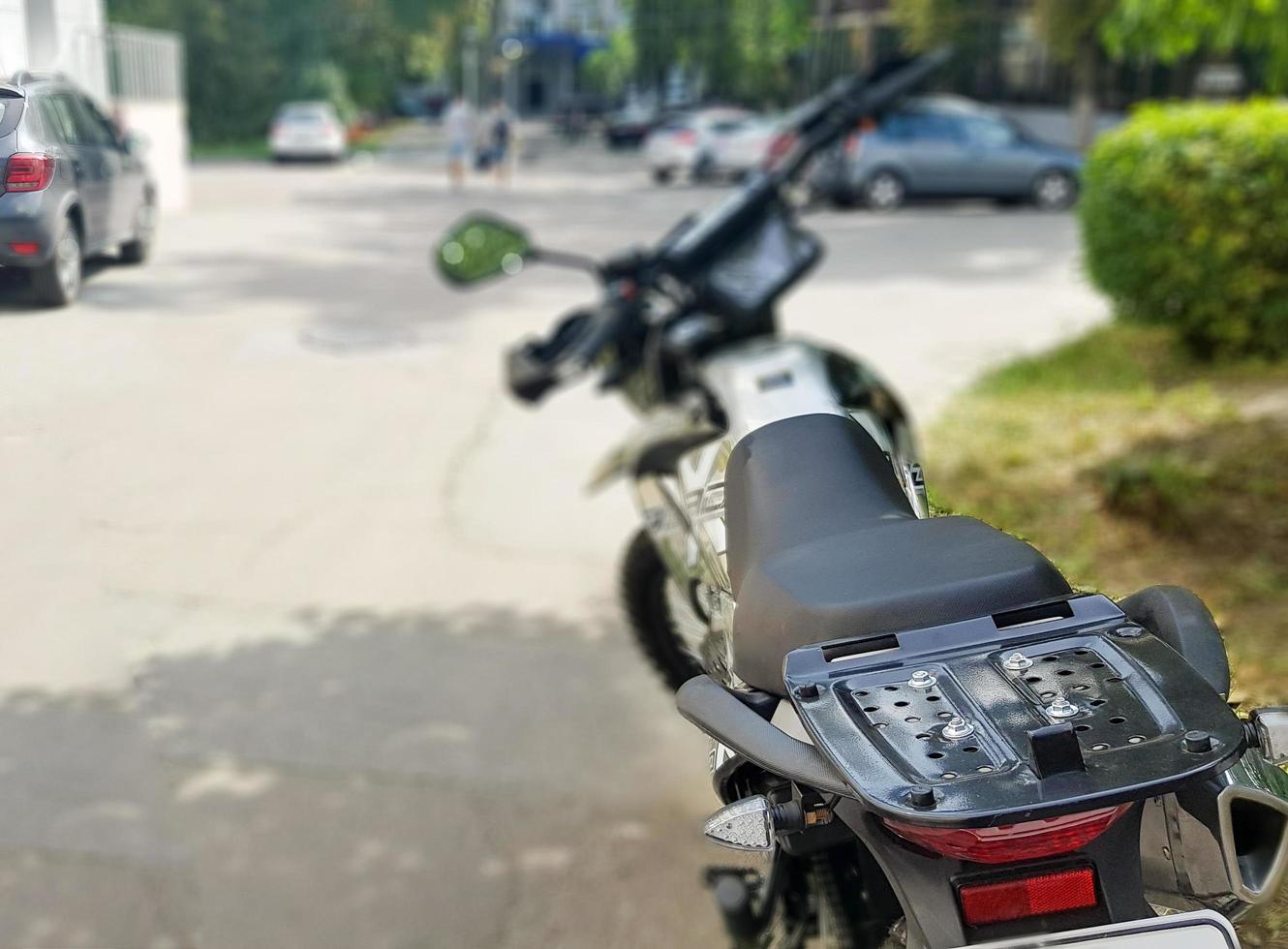 Black motorcycle parked. Back view. Soft focus photo