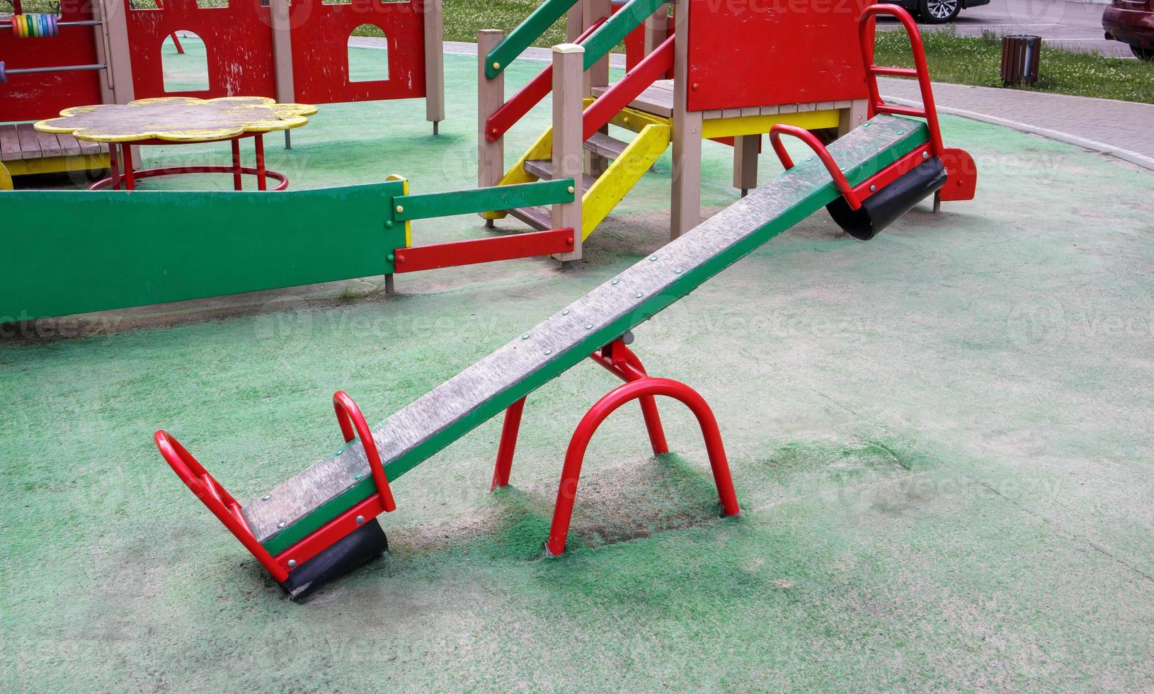 Closed modern playground. Security and protection measures against COVID-19 in the city park. Children's empty swing balancer in the park without people. The concept of childhood is over. photo
