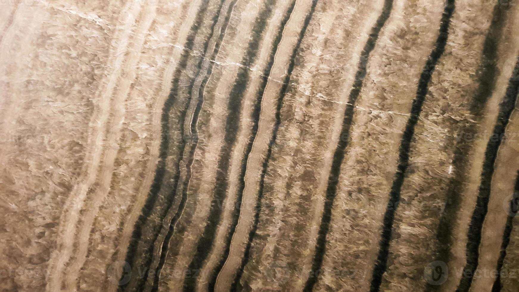 The surface of Sandstone with wavy brown veins. Sulphide agate texture. Wide image of brown natural stone texture Sphalerite. Beautiful wavy pattern of cut of Schalenblende stone close-up photo