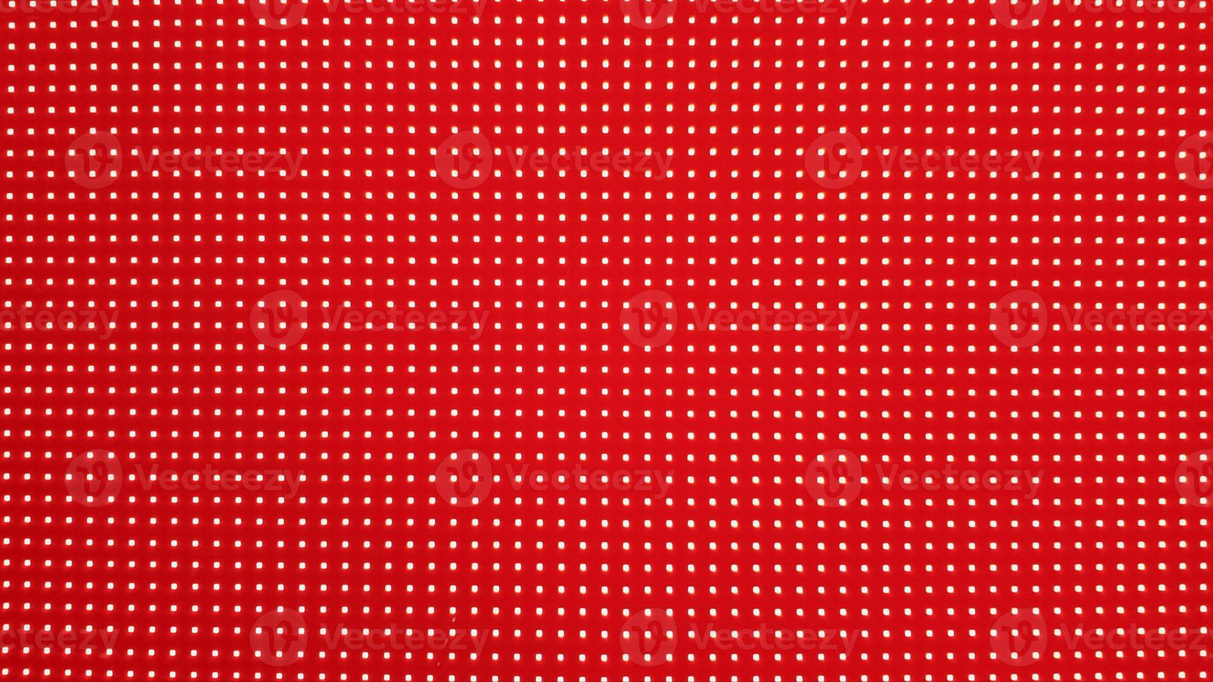 RGB LED screen panel texture. Close-up of a pixel LED screen with bokeh for wallpaper. Bright red abstract background perfect for any design. photo