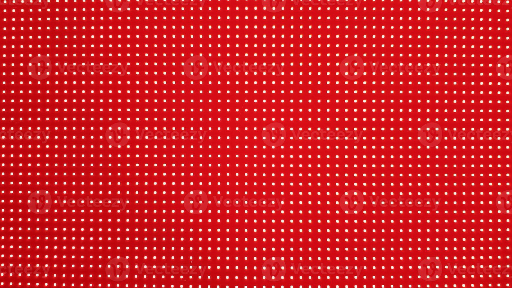 RGB LED screen panel texture. Close-up of a pixel LED screen with bokeh for wallpaper. Bright red abstract background perfect for any design. photo