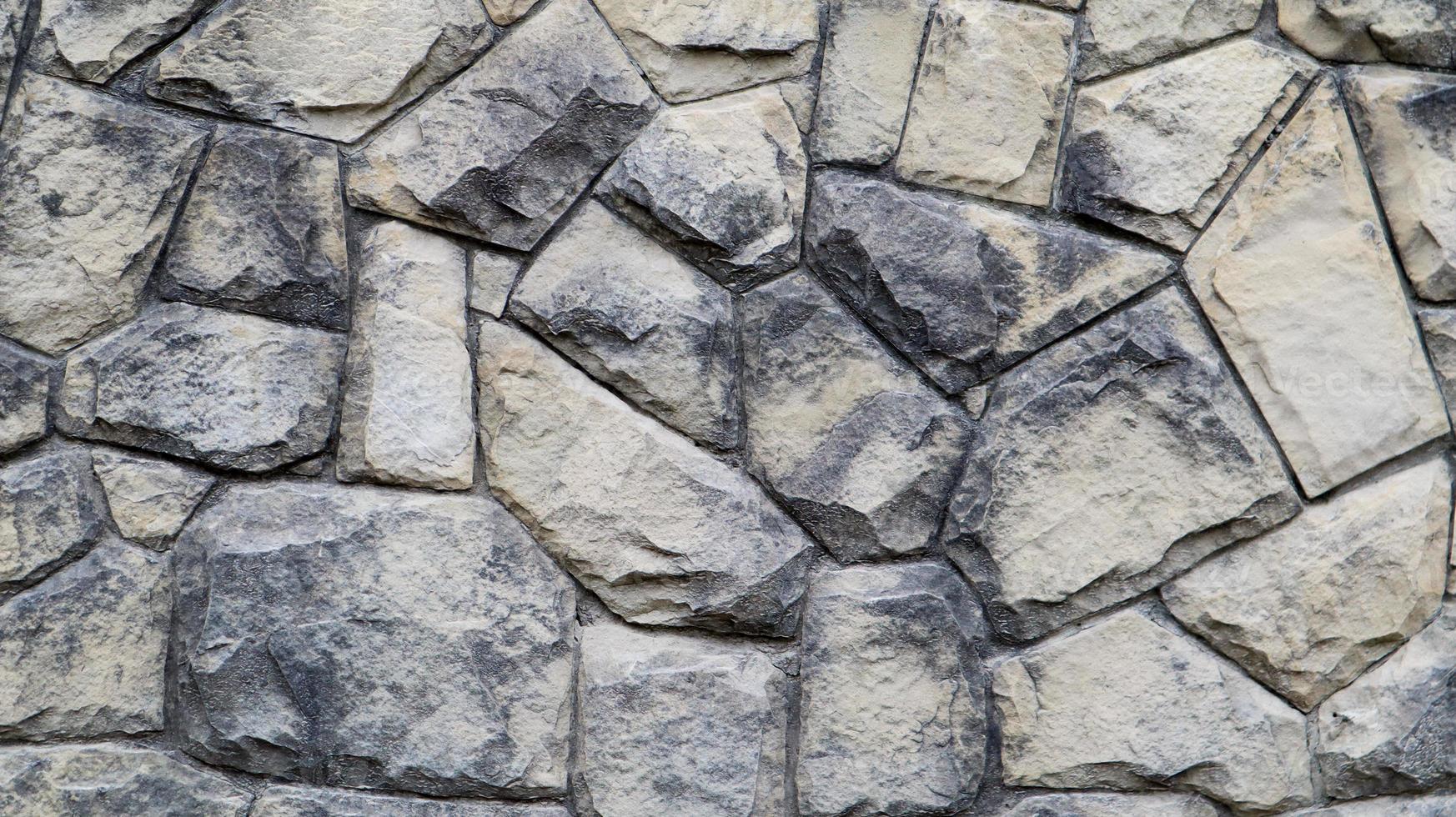 la textura del muro de piedra. Fondo de textura de pared de piedra de castillo viejo. muro de piedra como fondo o textura. parte de un muro de piedra, de fondo o textura. patrón de color gris diseño de estilo moderno foto