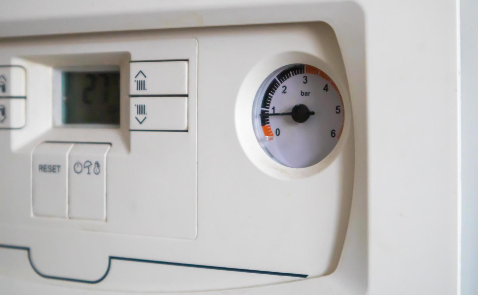 Internal control of a gas double-circuit boiler with a pressure and temperature sensor in the home heating system, close. Energy saving and image efficient home concept. Selective focus. photo