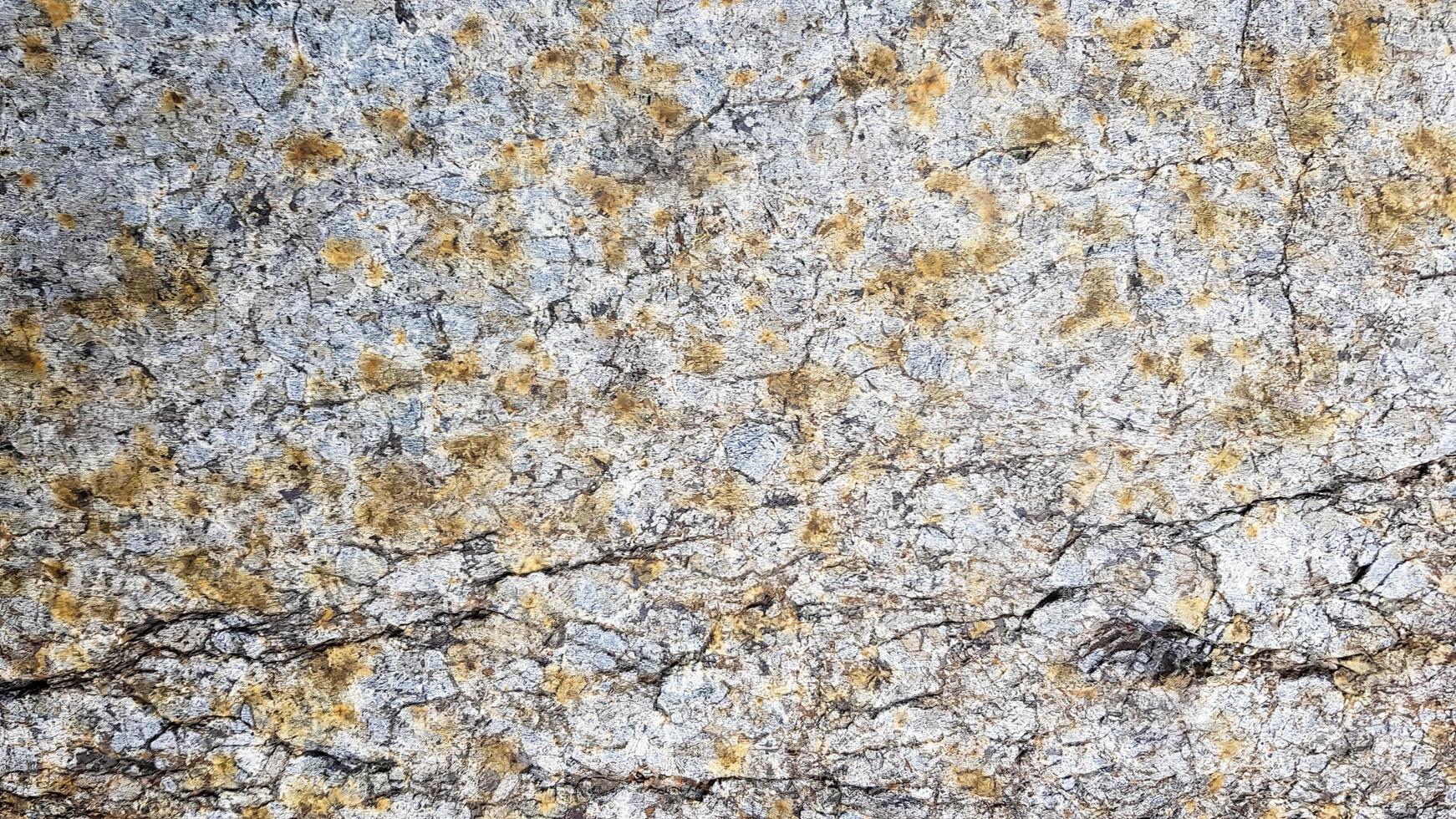 surface of the marble with brown tint. Details of sand stone texture, close up shot of rock surface with vignette at cover and bright spot at centre, idea for background or backdrop. photo