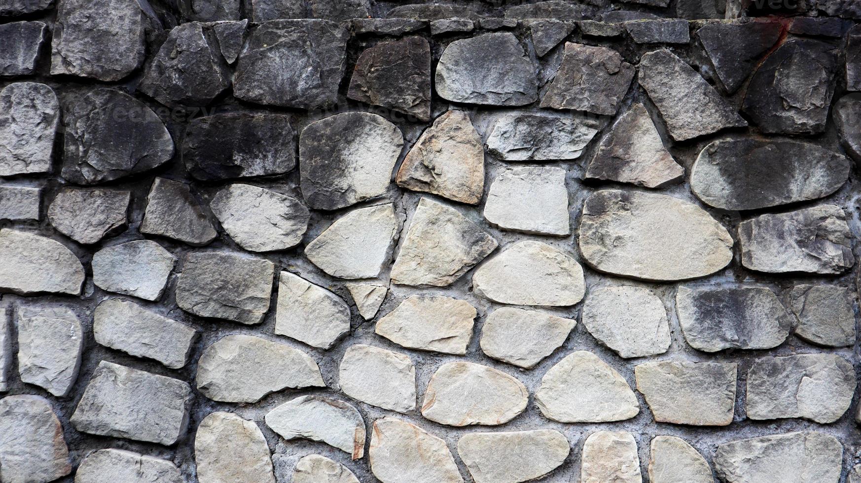 la textura del muro de piedra. Fondo de textura de pared de piedra de castillo viejo. muro de piedra como fondo o textura. parte de un muro de piedra, de fondo o textura. patrón de color gris diseño de estilo moderno foto