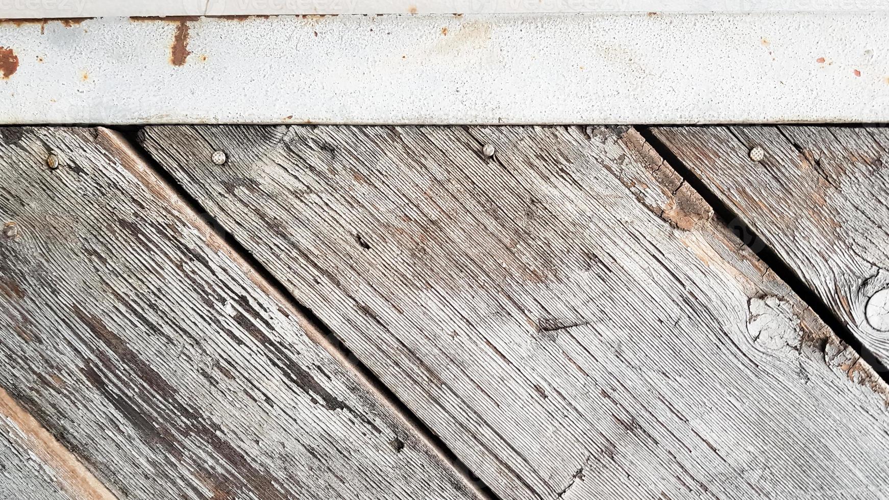 Gray wooden background with diagonal lines. Board background with copy space. Wooden old boards with cracked gray paint on the diagonal. Selective focus. Textured wooden background. photo
