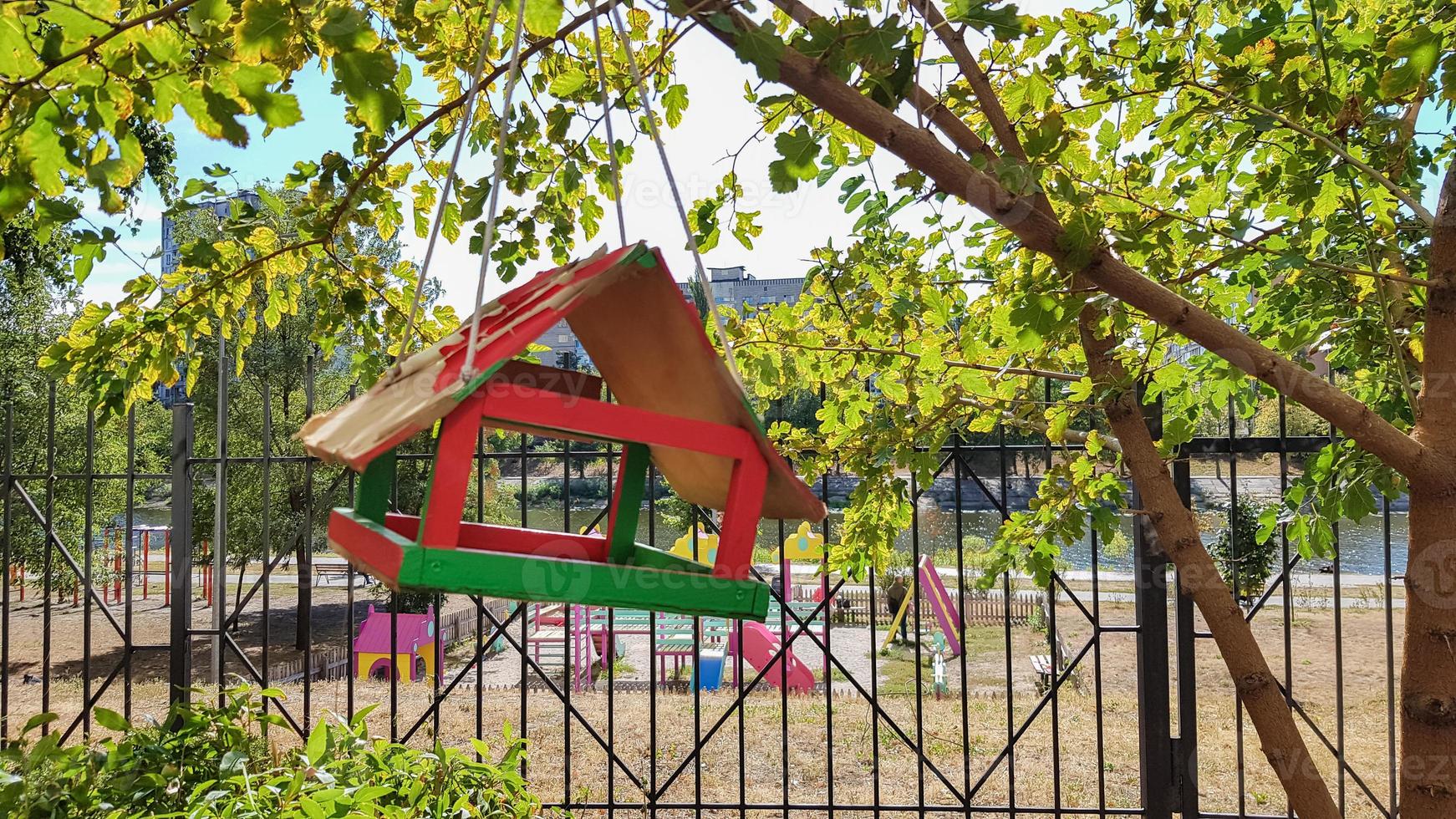 Handmade bird feeders made of wood in a city park. Bird house. photo