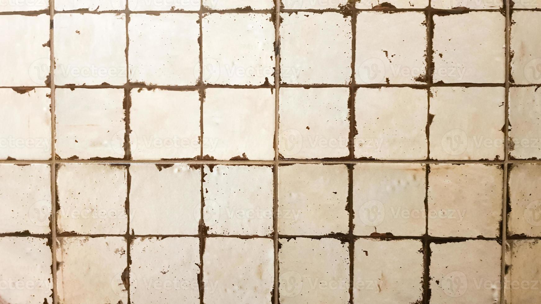 Tile wall. Old white tiles background. Ancient ceramic small square tiles for indoor and outdoor use with glossy and matte finish. photo