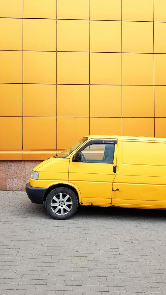 Ukraine, Kiev - March 27, 2020. Yellow Transporter in yellow on a background of a yellow building. photo