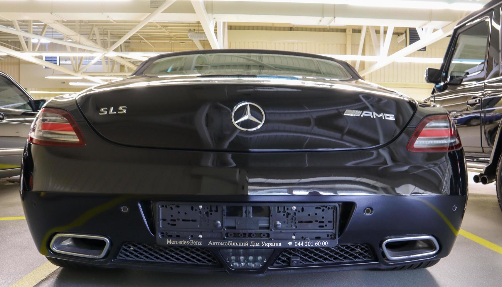 Mercedes Benz SLS amg Roadster, 2012. Double luxury supercar in the back of a coupe. The sports car is equipped with a 6.2 L V8 M159 engine. Ukraine, Kiev - June 09, 2021. photo