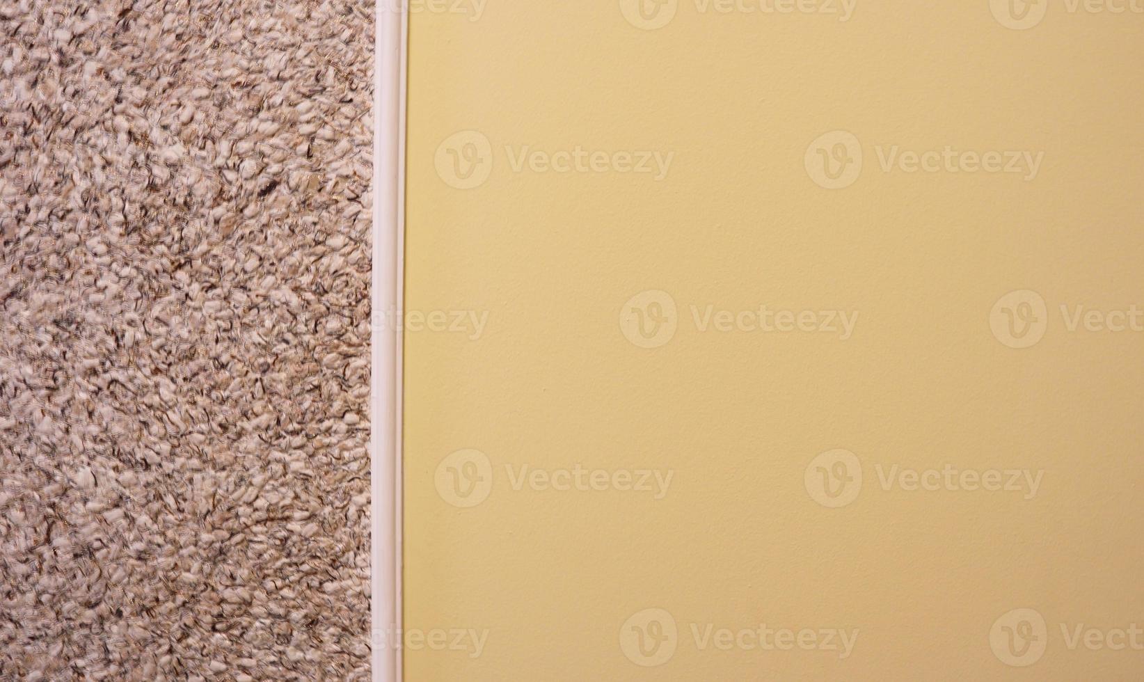 decorative plaster and semi-painted wall in beige. Textured background. Two color wall. The yellow and beige background is painted in two different colors. Abstract wallpaper. copy space photo