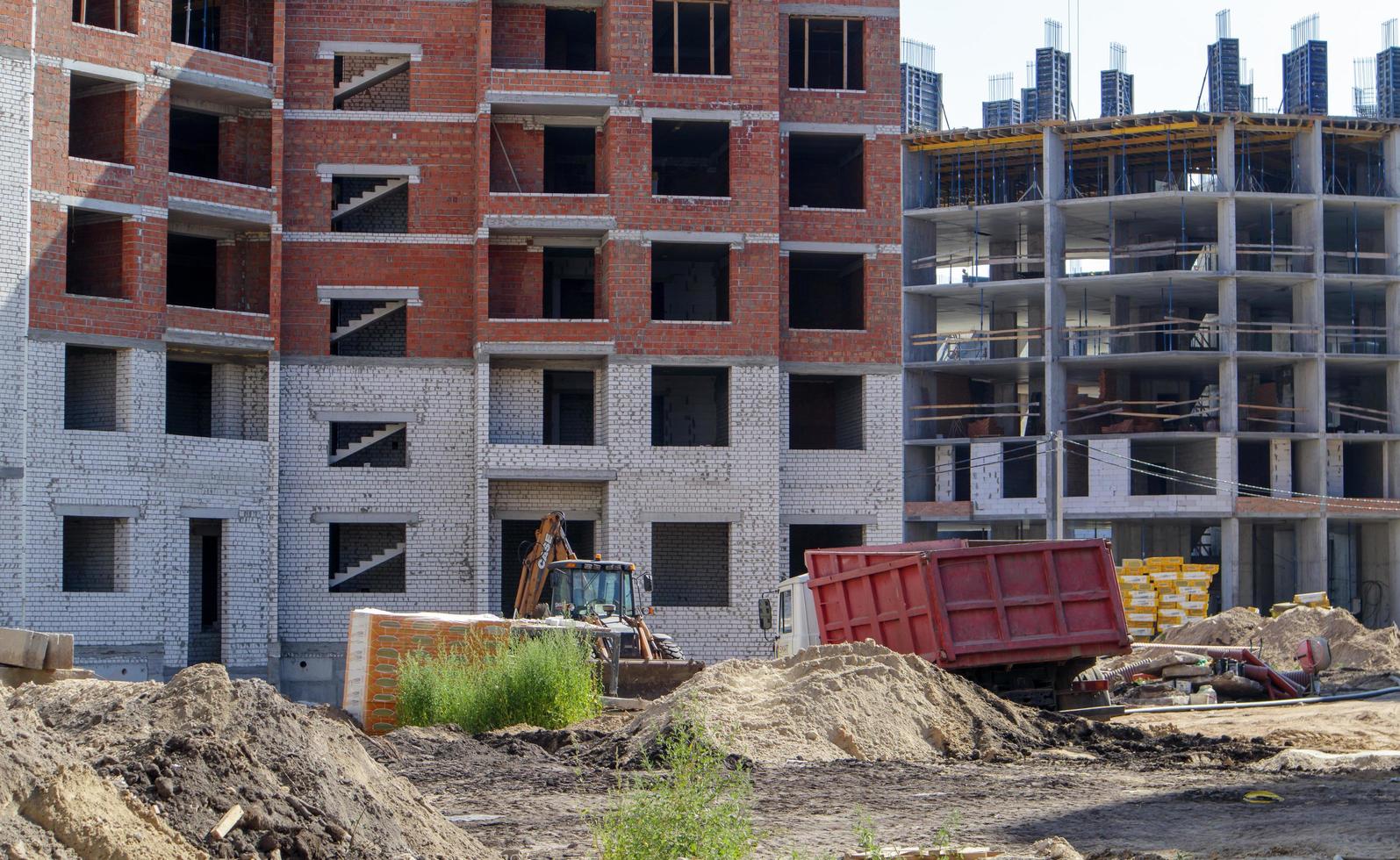 Large construction site. The process of capital construction of a high-rise residential complex. Concrete building, construction, industrial site. Ukraine, Kiev - August 28, 2021. photo