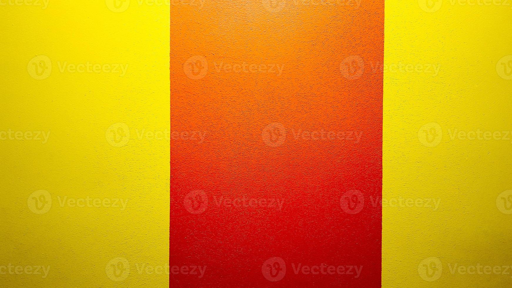 Red and yellow painted wall texture abstract grunge background with copy space. Abstract geometric pattern on the wall. The wall is divided into borders of different colors photo