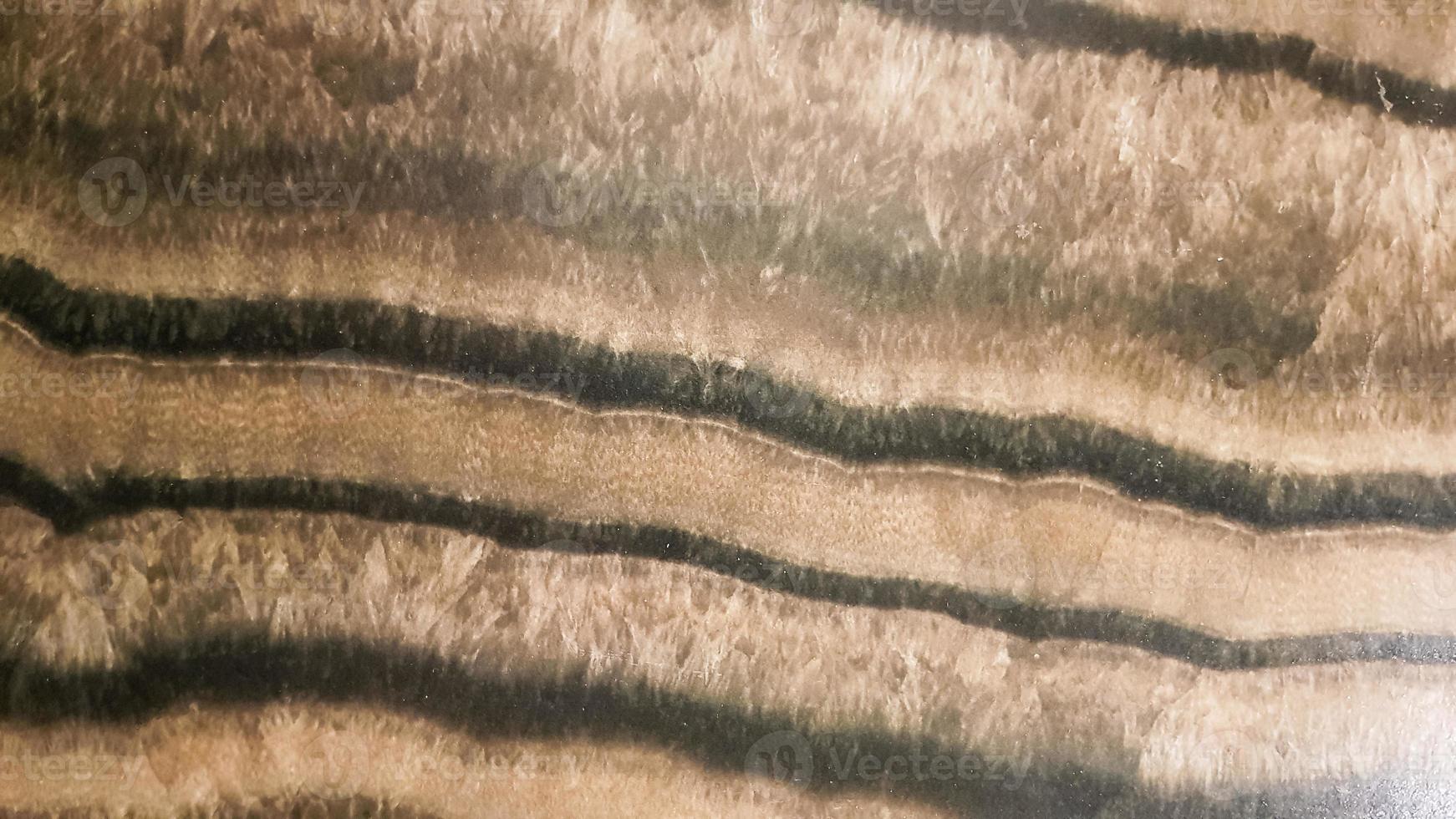 The surface of Sandstone with wavy brown veins. Sulphide agate texture. Wide image of brown natural stone texture Sphalerite. Beautiful wavy pattern of cut of Schalenblende stone close-up photo