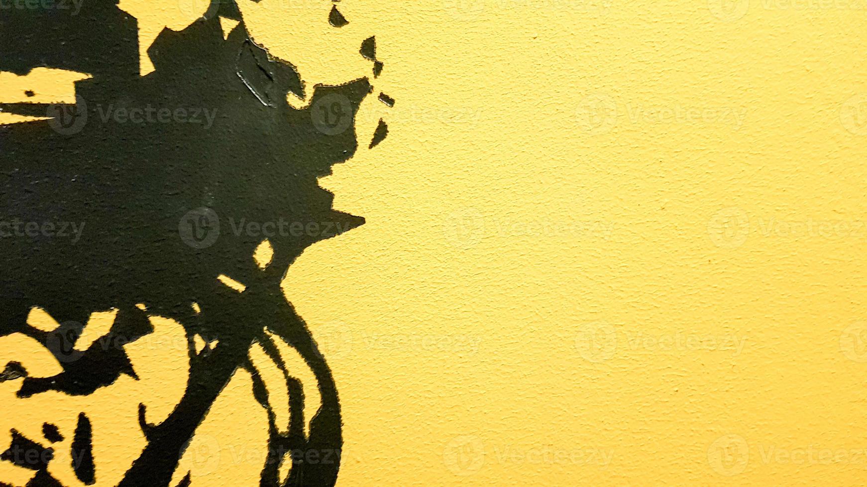 Black abstract paint splashes dripping on a bright yellow background. Black paint splashes on a yellow background. concept of art ideas. Paint brush texture yellow and black on background photo