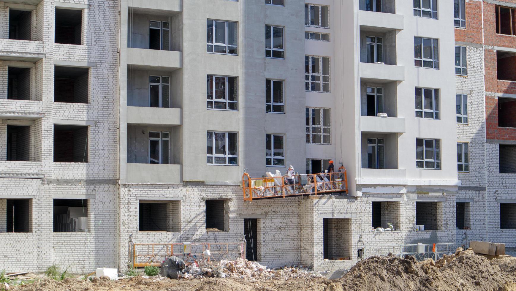 Large construction site. The process of capital construction of a high-rise residential complex. Concrete building, construction, industrial site. Ukraine, Kiev - August 28, 2021. photo