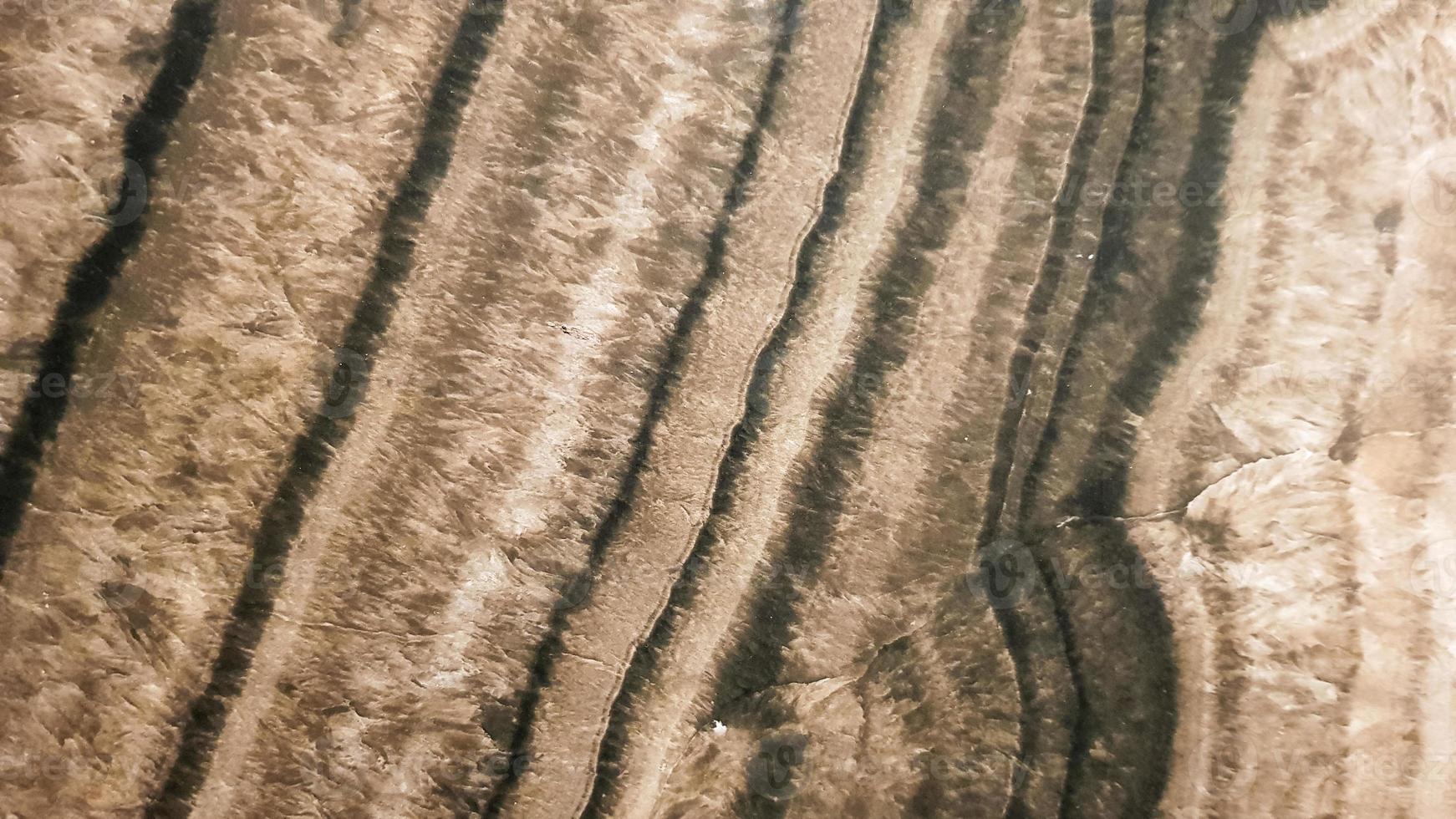 The surface of Sandstone with wavy brown veins. Sulphide agate texture. Wide image of brown natural stone texture Sphalerite. Beautiful wavy pattern of cut of Schalenblende stone close-up photo