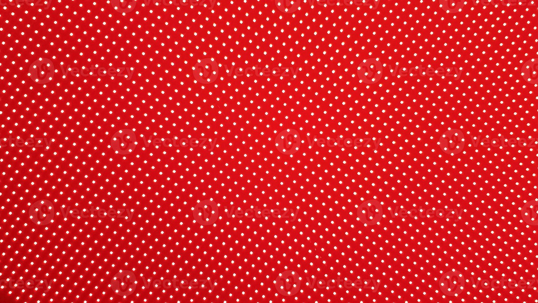 RGB LED screen panel texture. Close-up of a pixel LED screen with bokeh for wallpaper. Bright red abstract background perfect for any design. photo