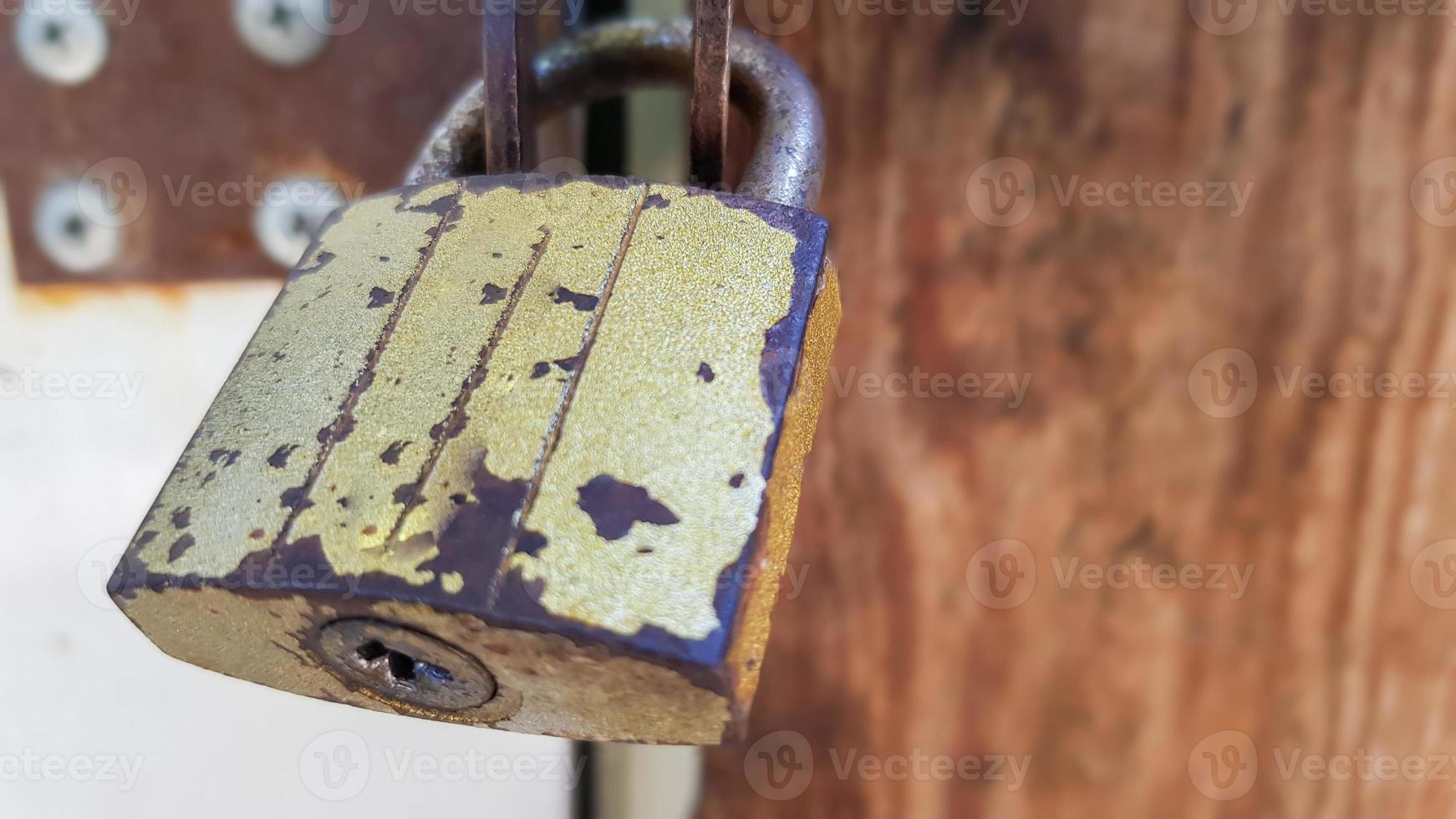 metal door with lock, texture and background. Background texture of an iron padlock on a rusty metal gate. photo