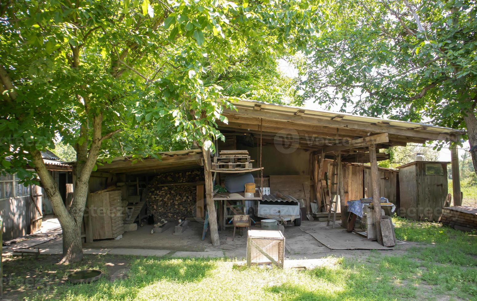 Old wooden barn in the village on a summer sunny day. photo