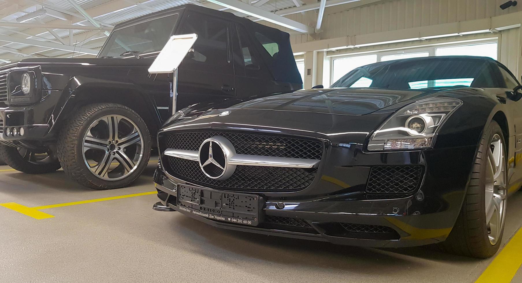 Mercedes Benz SLS amg Roadster, 2012. Double luxury supercar in the back of a coupe. The sports car is equipped with a 6.2 L V8 M159 engine. Ukraine, Kiev - June 09, 2021. photo