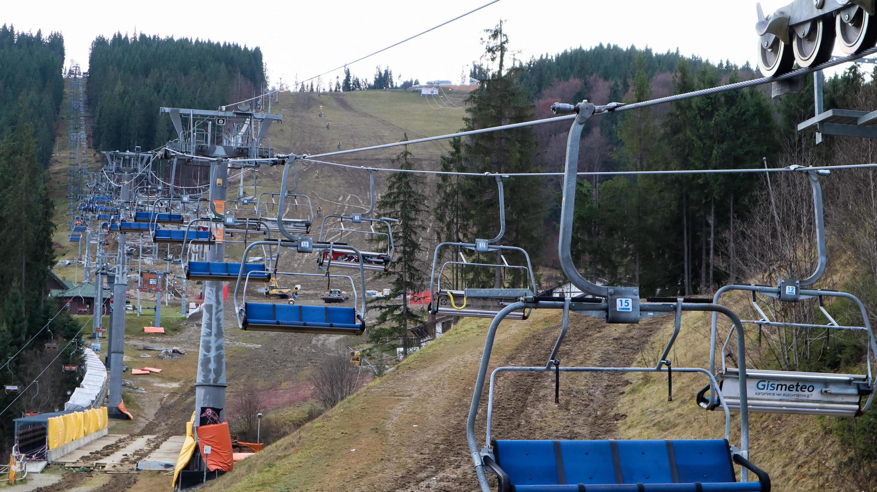 Ukraine, Bukovel - November 20, 2019. Autumn view of the ski resort with a chairlift against the background of autumn mountain slopes and the infrastructure under construction of a winter ski resort. photo