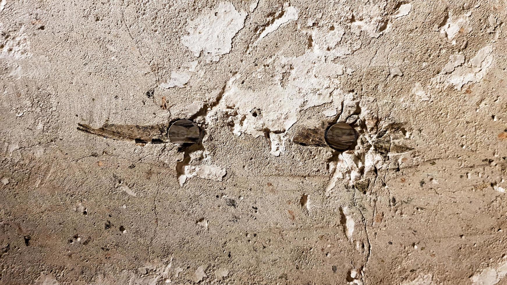 Reinforced concrete wall is useful as a background. Reinforced concrete with damaged metal fittings photo