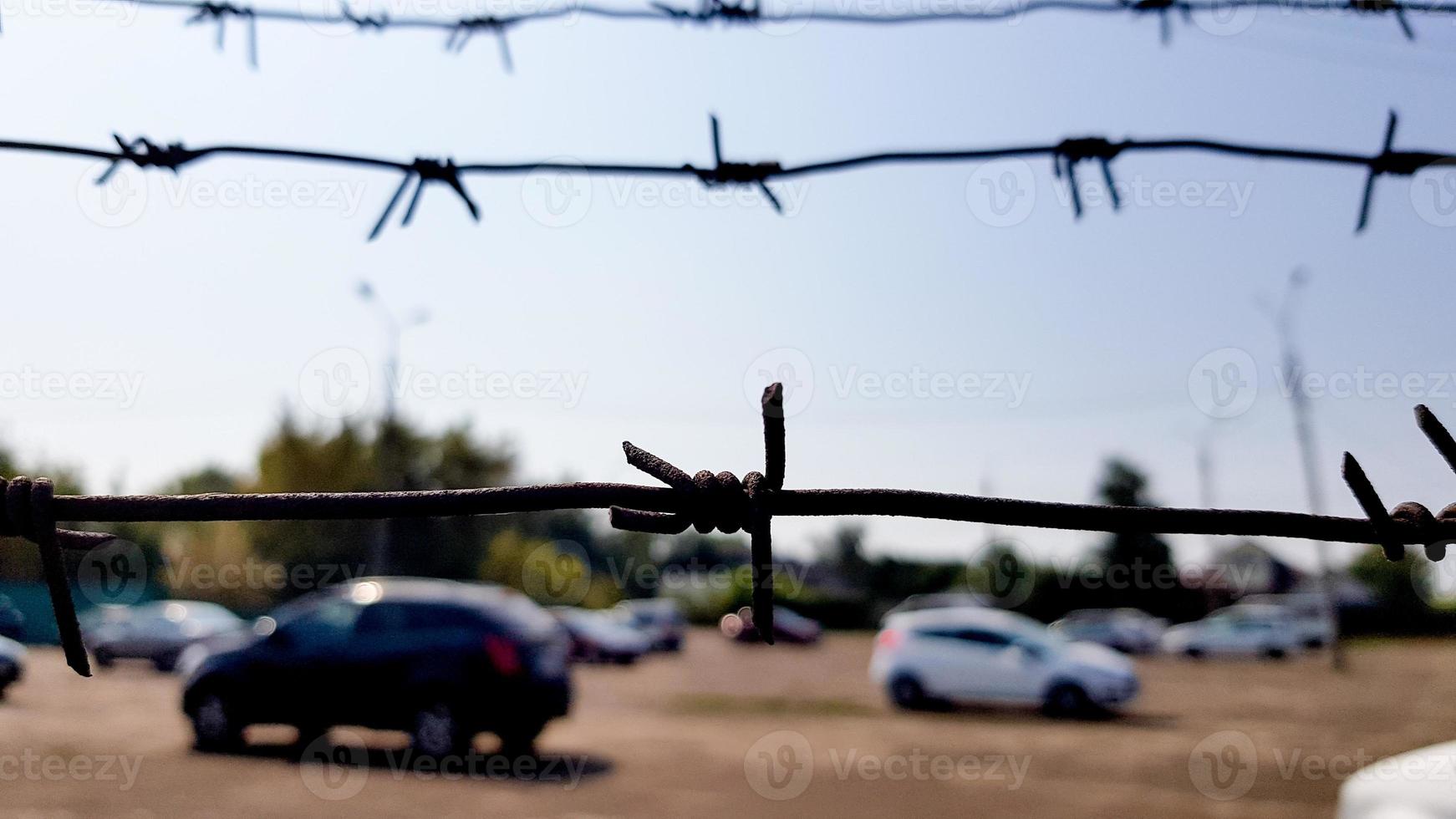 Cars behind a mesh fence. Security, guarded parking, fine, arrest concept photo