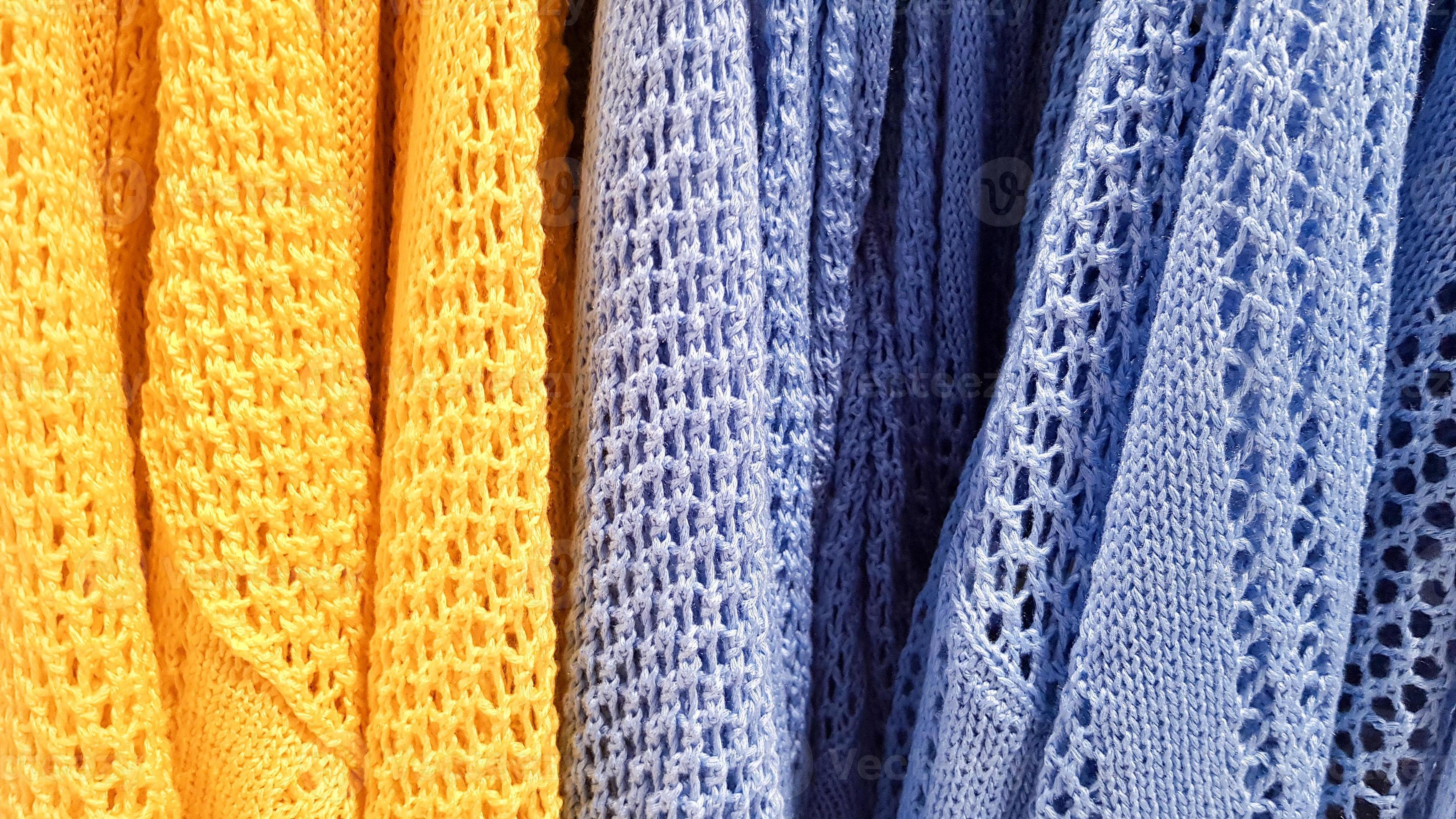 Colors of rainbow. Variety of casual shirts, t-shirts on hangers in a