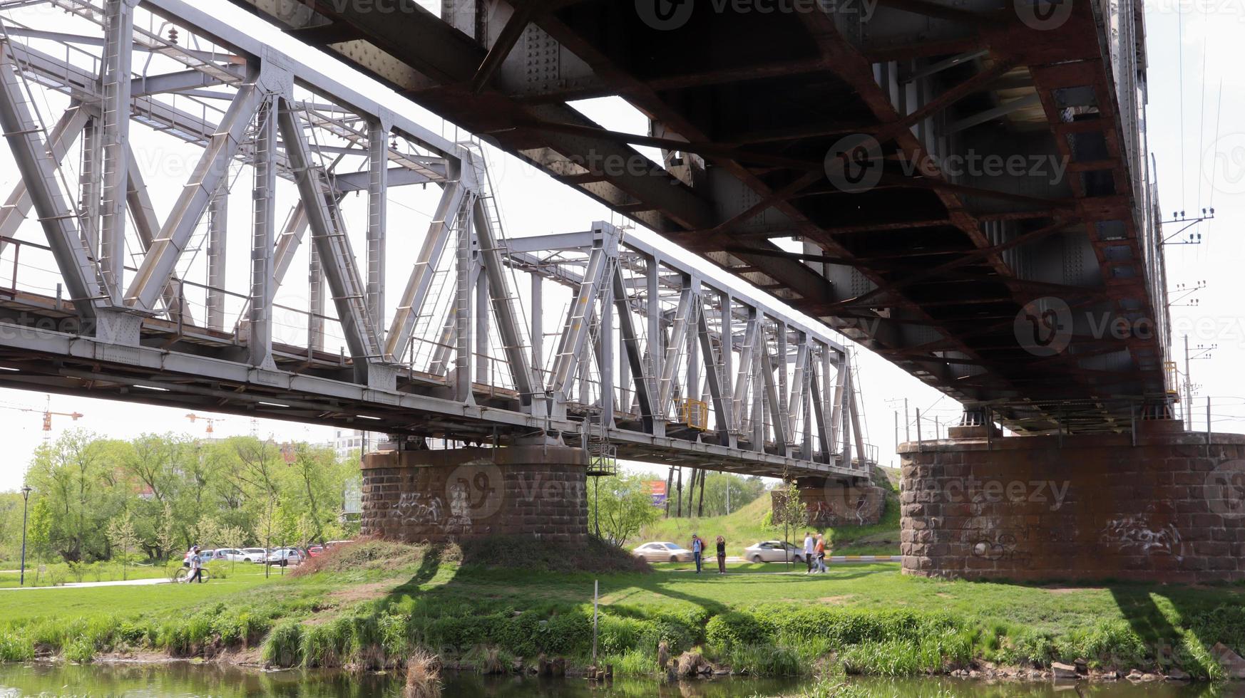 Railway bridge over the river, bottom view in the summer. photo