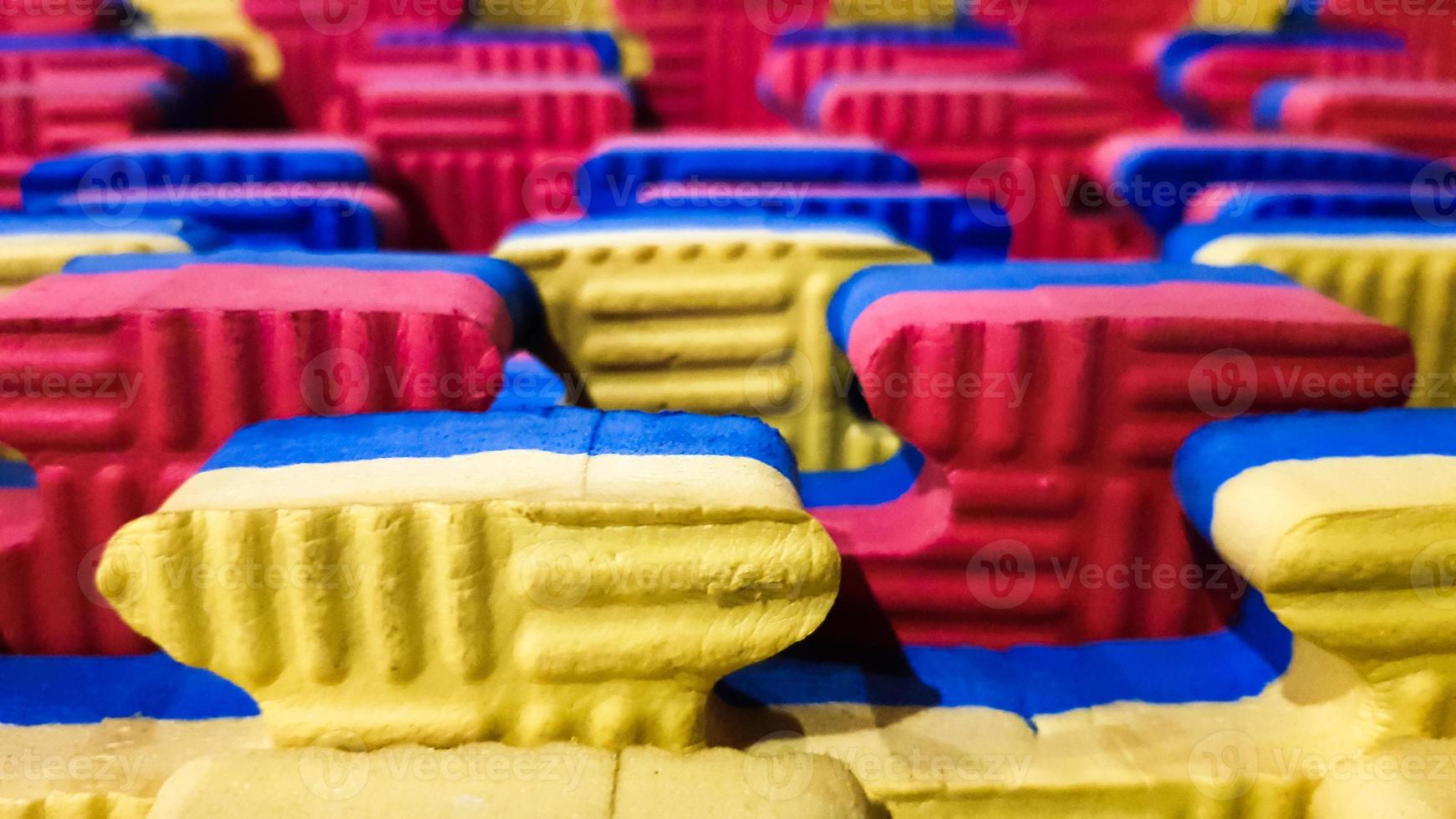 Orange blue and red game foam floor tiles. Foam floor, mats in the games room, kindergarten or gym. Potential use as a colorful background with copy space. photo