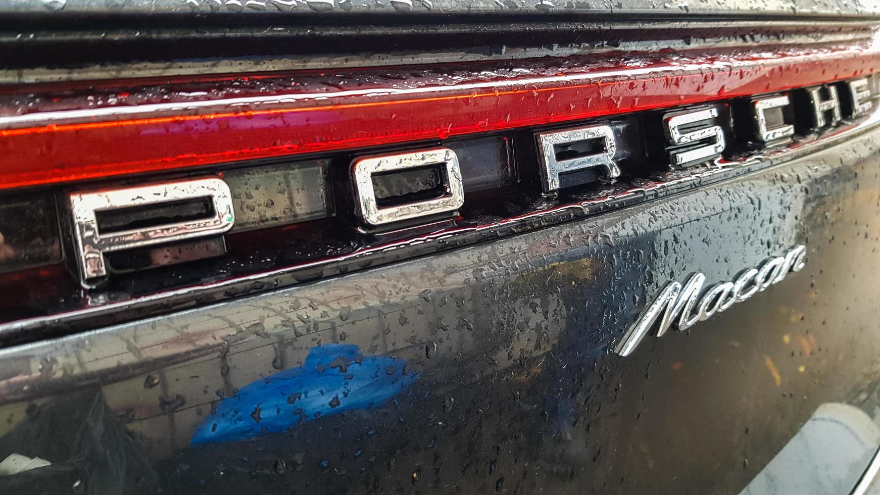 Ukraine, Kiev - March 27, 2020. Porsche Macan sports black car detailed rear view of the body with a logo. photo